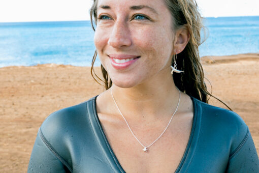 tiny honu necklace and humpback earrings on model