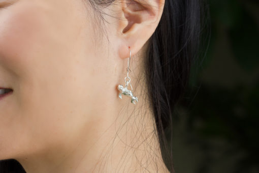 Monk seal earring on model - close